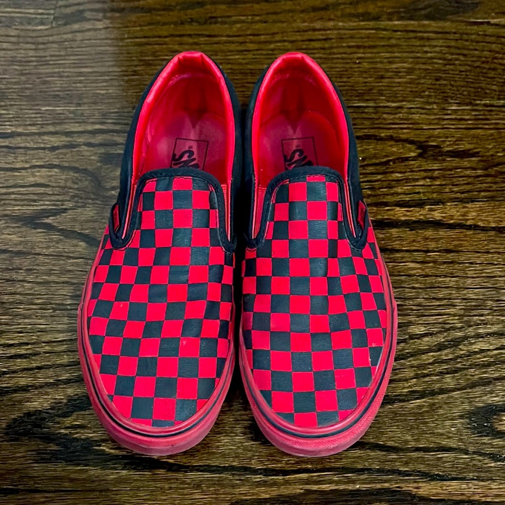 Vans red and black checker slip-ons.